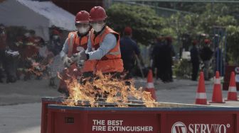 Peserta mengikuti simulasi penyelamatan saat kompetisi Fire Safety Challenge (FSC) antar Suku Dinas Pemadam Kebakaran di Kantor Dinas Penanggulangan Kebakaran dan Penyelamatan Pemprov DKI Jakarta, Gambir, Jakarta, Rabu (2/6/2021). [Suara.com/Angga Budhiyanto]