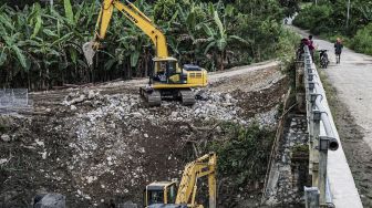 Sejumlah warga melihat proses pekerjaan normalisasi sungai di Arsopura, Kabupaten Keerom, Papua, Sabtu (12/06/2021). [ANTARA FOTO/Indrayadi TH]