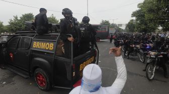 Massa pendukung Rizieq Shihab memaksa aparat kepolisian untuk berputar arah saat akan melintas di kawasan I Gusti Ngurah Rai, Jakarta, Kamis (24/6/2021). [Suara.com/Angga Budhiyanto]