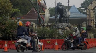 Calon pengunjung berada di depan gerbang utama Taman Margasatwa Ragunan, Jakarta, Minggu (27/6/2021). [Suara.com/Dian Latifah]