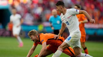 Bek Belanda Matthijs de Ligt (kiri) jatuh di atas bola saat menantang pemain depan Republik Ceko Patrik Schick selama  laga 16 besar Euro 2020 kontra Republik Ceko di Puskas Arena, Budapest, Hungaria, Senin (28/6/2021) dini hari WIB. Darko Bandic / POOL / AFP