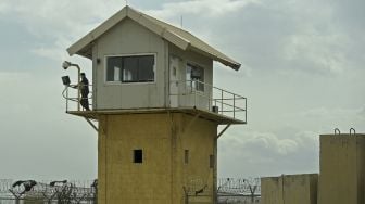 Seorang prajurit Tentara Nasional Afghanistan (ANA) bersiaga di menara penjaga di dalam pangkalan udara AS Bagram setelah semua pasukan AS dan NATO pergi, di Afghanistan, pada (5/7/2021). [WAKIL KOHSAR / AFP]