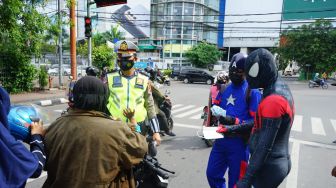 Polisi di Makassar Beraksi Bagi-bagi Masker Pakai Baju Superhero 