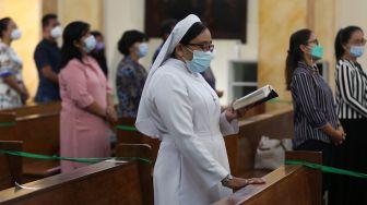 Umat kristiani melaksanakan ibadah dengan menjaga jarak dan memakai masker sebagai bagian pelaksanaan protokol kesehatan (prokes) COVID-19 di gereja Hati Kudus, Banda Aceh, Aceh, Minggu (25/7/2021). ANTARA FOTO / Irwansyah Putra