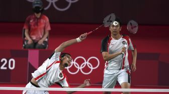 Pebulutangkis ganda putra Indonesia Mohammad Ahsan/Hendra Setiawan mengembalikan kok ke arah ganda putra Taiwan Lee Yang/Wang Chi-Lin dalam semifinal Olimpiade Tokyo 2020, di Musashino Forest Sport Plaza, Tokyo, Jepang, Jumat (30/7/2021). [ANTARA FOTO/Sigid Kurniawan]