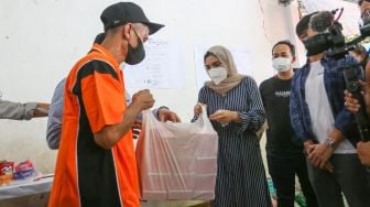 Aktris Ashanty memberikan bantuan berupa sembako kepada warga korban kebakaran di Jalan Karet Pasar Baru 1, Karet Tengsin, Jakarta Pusat, Jumat (6/8/2021). [Suara.com/Alfian Winanto]