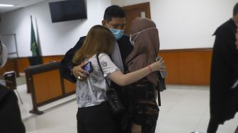 Ibunda Jeff Smith, Areistiani (kanan) dan Aisyah Aqilah (kiri) memeluk kuasa hukumnya usai vonis sidang kasus narkoba yang menjerat Jeff Smith di Pengadilan Negeri Jakarta Barat, Rabu (8/9/2021). [Suara.com/Alfian Winanto]