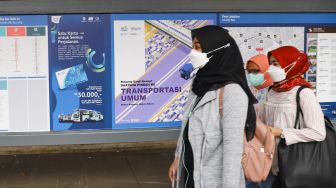 Warga melintas di Halte Stasiun Palmerah, Jakarta Pusat, Kamis (30/9/2021). [Suara.com/Alfian Winanto]