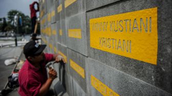 Pekerja memahat nama dari tenaga kesehatan yang gugur akibat COVID-19 di Monumen Gasibu, Bandung, Jawa Barat, Senin (4/10/2021).  ANTARA FOTO/Raisan Al Farisi