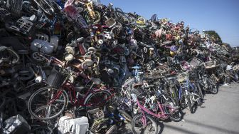 Sepeda dan suku cadang sepeda berada di tempat pembuangan sampah di Saitama, Jepang, pada (11/10/2021). [Charly TRIBALLEAU / AFP]