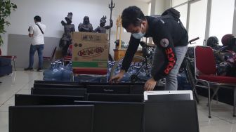 Petugas mengamankan barang bukti kejahatan sejumlah unit komputer usai penggerebekan kantor jasa pinjaman online (Pinjol) oleh Dit Reskrimsus Polda Metro Jaya di Cipondoh, Tangerang, Banten, Kamis (14/10/2021). ANTARA FOTO/Muhammad Iqbal 
