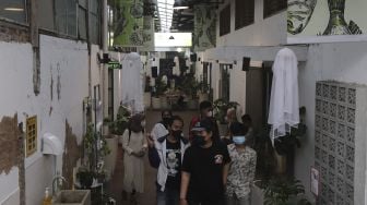 Pengunjung melintas di dekat ornamen Halloween yang terpasang di M Bloc Space, Blok M, Jakarta, Minggu (31/10/2021). [Suara.com/Angga Budhiyanto]