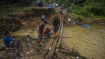 Sejumlah warga bergotong royong membangun jembatan darurat di Desa Murung B, Kecamatan Hantakan, Kalimantan Selatan, Senin (8/11/2021). [ANTARA FOTO/Bayu Pratama S]