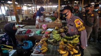Petugas Satgas COVID-19 berbincang dengan pedagang saat melakukan razia warga yang belum divaksin COVID-19 di Pasar Bandung, Tegal, Jawa Tengah, Kamis (11/11/2021). ANTARA FOTO/Oky Lukmansyah