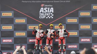 Pembalap IATC Furusato (tengah), Daniel Sharil (kiri) dan Gun Mie (kanan) berpose saat naik podium balapan hari pertama Idemitsu Asia Talent Cup (IATC) atau MotoGP Junior di Pertamina Mandalika International Street Circuit di KEK Mandalika, Desa Kuta, Kecamatan Pujut, Praya, Lombok Tengah, NTB, Jumat (19/11/2021). [ANTARA FOTO/Ahmad Subaidi]