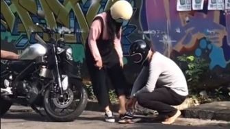 Aksi Romantis Pria Bermotor Serahkan Sepatunya ke Pasangan, Tuai Perdebatan Publik