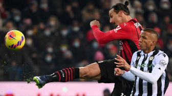 Pemain depan AC Milan Zlatan Ibrahimovic menendang bola selama pertandingan sepak bola Serie A Italia antara Udinese melawan AC Milan di stadion Dacia Arena, Minggu (12/12/2021) dini hari WIB.  Marco BERTORELLO / AFP
