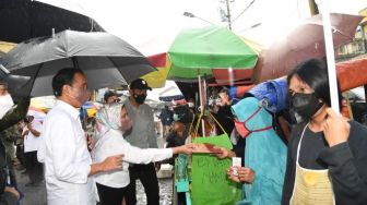 Sepayung Berdua, Jokowi dan Iriana Serahkan Bantuan Tunai ke Pedagang di Pasar Kertek