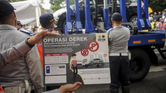 Petugas Dinas Perhubungan menunjukan stiker mobil derek hidrolik otomatis setelah diresmikan di Bandung, Jawa Barat, Kamis (30/12/2021). [ANTARA FOTO/Raisan Al Farisi]