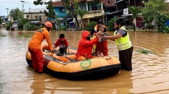 Petugas Basarnas mengevakuasi warga yang terjebak banjir di permukiman kawasan Kali Acai Abepura, Papua, Jumat (7/1/2022). ANTARA FOTO/Fredy Fakdawer