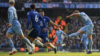 Gelandang Manchester City Kevin De Bruyne (kanan) mencetak gol pembuka pada pertandingan sepak bola Liga Inggris antara Manchester City dan Chelsea di Stadion Etihad, Manchester, Inggris, Sabtu (15/1/2022). [OLI SCARFF / AFP]