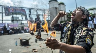 Warga yang tergabung dalam Aliansi Komunitas Budaya Jawa Barat melakukan atraksi debus saat berunjuk rasa di depan gedung Kompleks Parlemen, Senayan, Jakarta, Kamis (27/1/2022).  ANTARA FOTO/Muhammad Adimaja