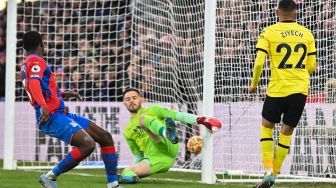 Gelandang Chelsea Hakim Ziyech (kanan) menembak dan mencetak gol melewati kiper Crystal Palace Jack Butland (tengah) saat pertandingan sepak bola Liga Premier Inggris antara Crystal Palace dan Chelsea di Stadion Selhurst Park, London, Inggris, Sabtu (19/2/2022). [Glyn KIRK / AFP]