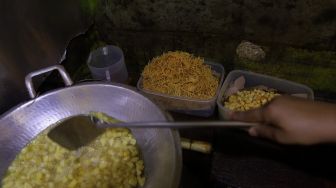 Penjual menggoreng kentang di salah satu warung di kawasan Jati Padang, Pasar Minggu, Jakarta, Rabu (23/2/2022). [Suara.com/Angga Budhiyanto] 