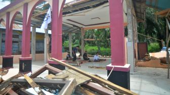 Warga melaksanakan shalat zuhur di mushalla yang rusak akibat gempa di Lubuk Panjang, Nagari Kajai, Kabupaten Pasaman Barat, Sumatera Barat, Selasa (8/3/2022). ANTARA FOTO/Iggoy el Fitra