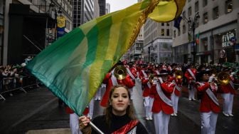 Para peserta berbaris saat parade perayaan Hari St. Patrick di New York, Amerika Serikat, Kamis (17/3/2022). [Ed JONES / AFP]
