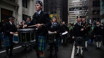 Para peserta berbaris saat parade perayaan Hari St. Patrick di New York, Amerika Serikat, Kamis (17/3/2022). [Ed JONES / AFP]
