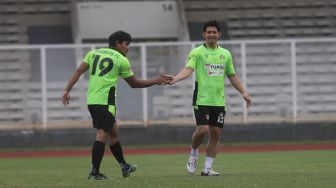 Aktor Iko Uwais bersalaman dengan YouTuber Haris Saputra atau Maell Lee saat bermain sepakbola bersama Selebritis FC di Stadion Madya, Kompleks Gelora Bung Karno, Jakarta, Senin (21/3/2022). [Suara.com/Angga Budhiyanto]