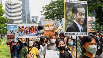 Massa dari berbagai komunitas saat menggelar aksi darurat iklim di Jalan Sudirman, Jakarta Pusat, Jumat (25/3/2022). [Suara.com/Alfian Winanto]