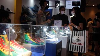 Pengunjung memilih koleksi sepatu sneaker saat Event Jakarta Sneaker Day (JSD) di Mall Senayan City, Jakarta Pusat, Jumat (25/3/2022). [Suara.com/Septian]