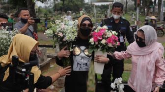 Mantan Politikus Angelina Sondakh tiba untuk berziarah ke makam suaminya, Adjie Massaid di TPU Jeruk Purut, Jakarta, Rabu (30/3/2022). [Suara.com/Angga Budhiyanto]