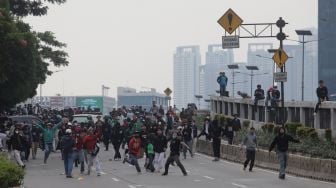 Massa aksi terlibat kericuhan dengan polisi saat unjuk rasa di sekitar gedung DPR RI, Jakarta, Senin (11/4/2022). [Suara.com/Angga Budhiyanto]