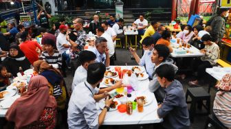 Suasana saat berbuka puasa di Sentra kuliner Nasi Kapau di Jalan Kramat Raya, Senen, Jakarta Pusat, Selasa (12/4/2021). [Suara.com/Alfian Winanto]