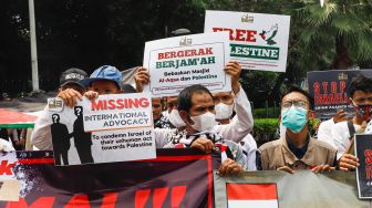 Sejumlah massa dari lembaga kemanusiaan Aqsa Working Group (AWG) saat menggelar aksi Bela Al-Aqsa di depan Kedutaan Besar Amerika di Jalan Medan Merdeka Selatan, Jakarta Pusat, Rabu (20/4/2022). [Suara.com/Alfian Winanto]