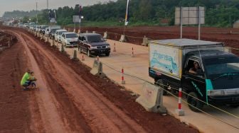 Sejumlah kendaraan antre melintas di kawasan proyek pembangunan Jalan Tol Jakarta-Cikampek 2 Selatan dari arah Sadang di Purwakarta, Jawa Barat, Jumat (29/4/2022).  ANTARA FOTO/M Risyal Hidayat