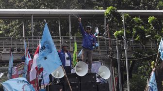 Massa buruh melakukan aksi unjuk rasa di kawasan Patung Kuda Arjuna Wiwaha, Jakarta, Kamis (12/5/2022). [Suara.com/Angga Budhiyanto]