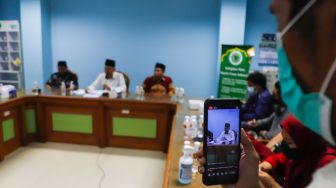 Ketua Komisi Fatwa MUI Asrorun Niam Soleh (tengah) saat memberikan keterangan pers terkait fatwa kurban ditengah wabah PMK di Gedung MUI Pusat, Jakarta Pusat, Selasa (31/5/2022). [Suara.com/Alfian Winanto]