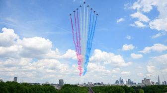 Tim Aerobatik Angkatan Udara Kerajaan Inggris, Red Arrows, terbang dalam formasi khusus diatas Istana Buckingham saat perayaan 70 tahun tahta Ratu atau Queen Platinum Jubilee di London, Ingrris, Kamis (2/6/2022). [Paul ELLIS / POOL / AFP]
