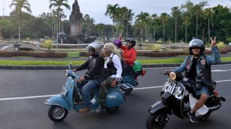 Pecinta vespa mengendarai sepeda motornya saat Vespa World Days (VWD) 2022 di Nusa Dua, Bali, Jumat (10/6/2022). [ANTARA FOTO/Fikri Yusuf/nym]