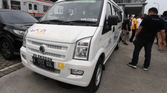 Warga melihat armada TRON Shuttle angkutan pengumpan berbasis listrik tujuan Stasiun Duri - Taman Baharia PIK saat peluncuran masa uji coba di Stasiun Duri, Jakarta, Jumat (17/6/2022). [ANTARA FOTO/Hafidz Mubarak A/foc]