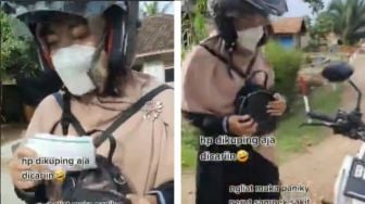 Panik Cari-Cari, Wanita Ini Tak Sadar Ponselnya Nyangkut di Helm