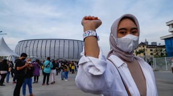 Warga berfoto dengan latar belakang Jakarta International Stadium (JIS), Sunter, Jakarta Utara, Sabtu (25/6/2022). [Suara.com/Alfian Winanto]
