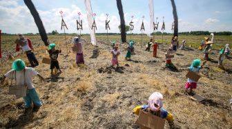 Sejumlah orang-orangan sawah berbahan jerami terpasang pada Festival Anak Sawah di kawasan persawahan Kampung Lali Gadget (KLG), Desa Pagerngumbuk, Wonoayu, Sidoarjo, Jawa Timur, Minggu (3/7/2022). [ANTARA FOTO/Umarul Faruq/nym]