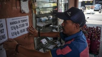 Pekerja memasang kertas harga baru gas elpiji non subsidi di agen LPG nonsubsidi Jalan Emong, Bandung, Jawa Barat, Selasa (12/7/2022). ANTARA FOTO/Raisan Al Farisi