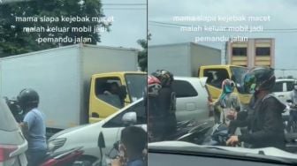 Terjebak Macet, Ibu Ini Malah Keluar dari Mobil dan Atur Jalan