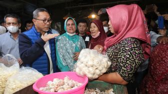 Menteri Perdagangan Zulkifli Hasan (kedua kiri) berbincang dengan pembeli saat melakukan kunjungan di Pasar Keputran Surabaya, Jawa Timur, Sabtu (30/7/2022).  ANTARA FOTO/Didik Suhartono